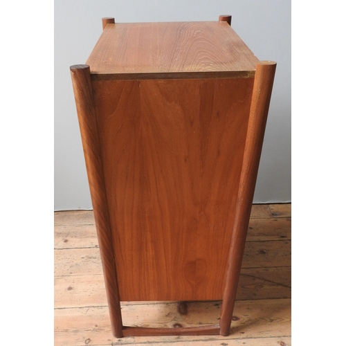 69 - A RETRO TEAK CHEST OF FIVE DRAWERS, circa 1970, with unusual circular split handles, supported on tw... 