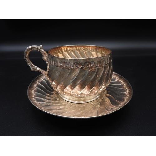 450 - A CONTINENTAL WHITE METAL CUP AND SAUCER, along with a continental white metal basket, two silver di... 