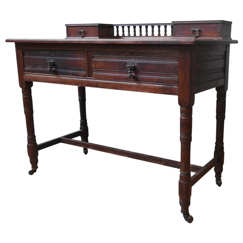 81 - A LATE 19TH CENTURY OAK WRITING TABLE, the leather top with two small drawers united by spindle back... 