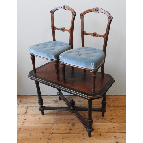 83 - A VICTORIAN WALNUT EBONISED SIDE TABLE, the canted corner top raised on four fluted legs united by a... 