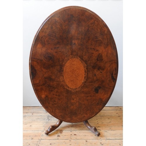 84 - A VICTORIAN WALNUT LOOE TABLE, the oval top inset with a central burr walnut panel, on a baluster pe... 