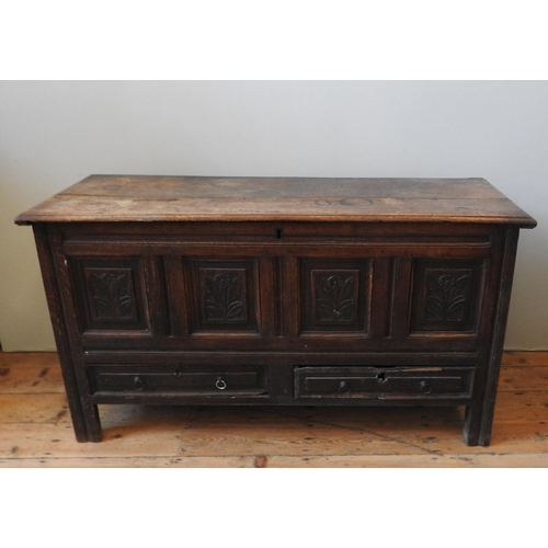 85 - AN EARLY 19TH CENTURY OAK COFFER, with four floral carved panels above two short frieze drawers, the... 