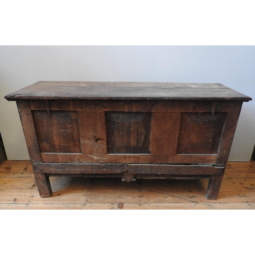 85 - AN EARLY 19TH CENTURY OAK COFFER, with four floral carved panels above two short frieze drawers, the... 