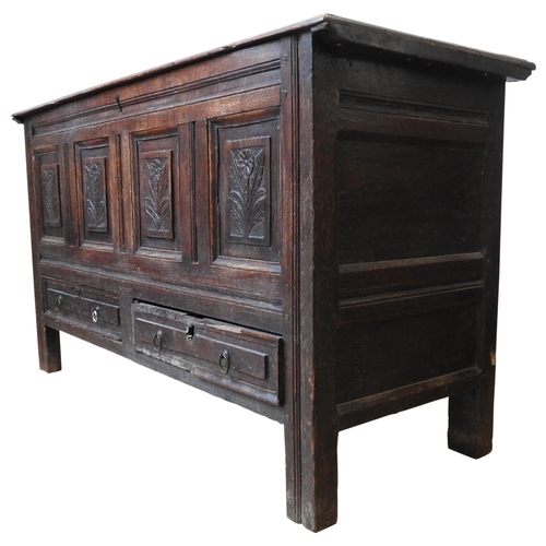 85 - AN EARLY 19TH CENTURY OAK COFFER, with four floral carved panels above two short frieze drawers, the... 