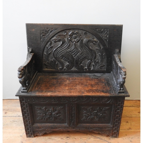 90 - A 19TH CENTURY CARVED OAK MONK'S BENCH, of small proportions, the ornate carved panels depicting gri... 