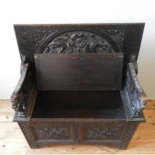 90 - A 19TH CENTURY CARVED OAK MONK'S BENCH, of small proportions, the ornate carved panels depicting gri... 