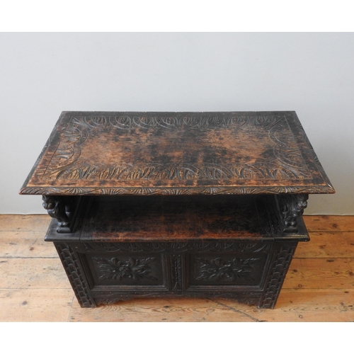 90 - A 19TH CENTURY CARVED OAK MONK'S BENCH, of small proportions, the ornate carved panels depicting gri... 