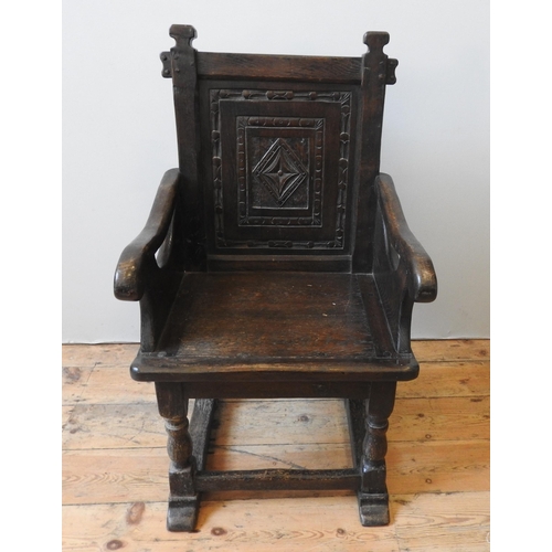 94 - AN 18TH CENTURY OAK WAINSCOT CHAIR, the back panel carved with central lozenge motif and concentric ... 