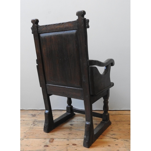 94 - AN 18TH CENTURY OAK WAINSCOT CHAIR, the back panel carved with central lozenge motif and concentric ... 