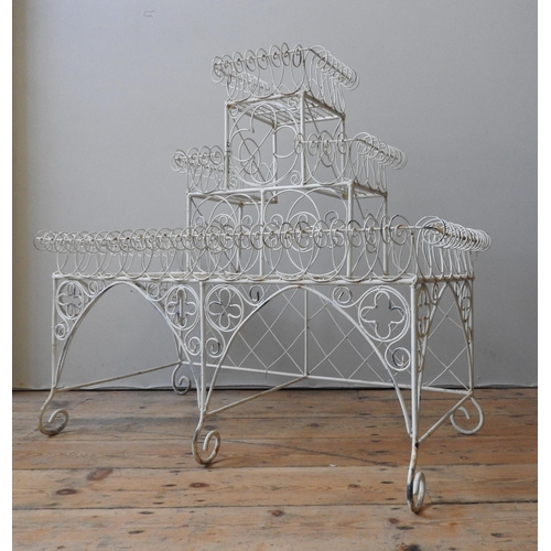 118 - A CREAM PAINTED VINTAGE THREE TIER METAL PLANT STAND, comprising of three graduated tiers, with scro... 