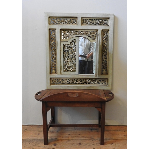 162 - AN CONTEMPORARY FRET WORK SHUTTER DOOR MIRROR, painted pale green with ornate foliate decorated pane... 