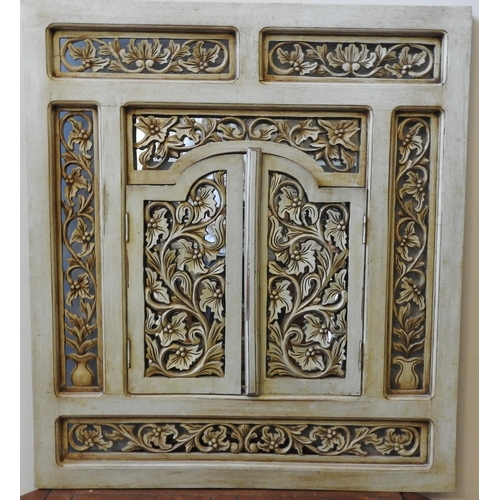 162 - AN CONTEMPORARY FRET WORK SHUTTER DOOR MIRROR, painted pale green with ornate foliate decorated pane... 