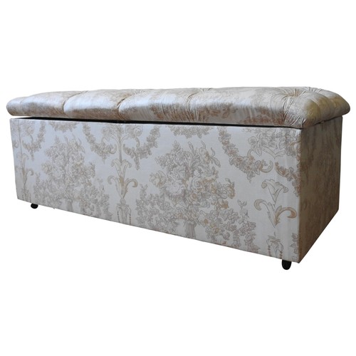 105 - A BUTTONED SEAT UPHOLSTERED OTTOMAN, covered in floral spray patterned material, 55 x 142 x 64 cm