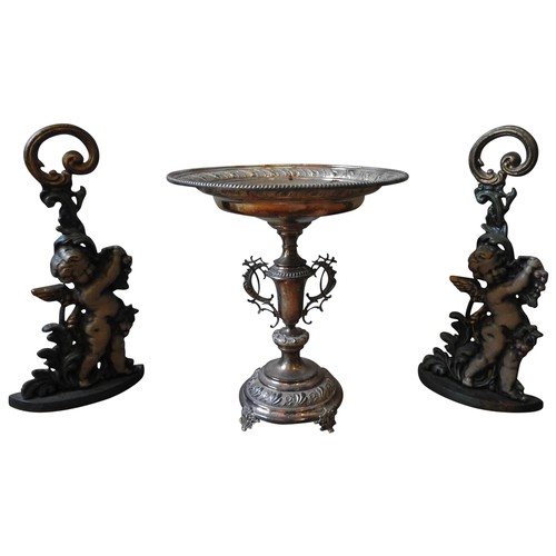 123 - A SILVER PLATED EPERGNE AND TWO CONTEMPORARY CAST-IRON DOOR STOPS, the epergne with two ornate handl... 