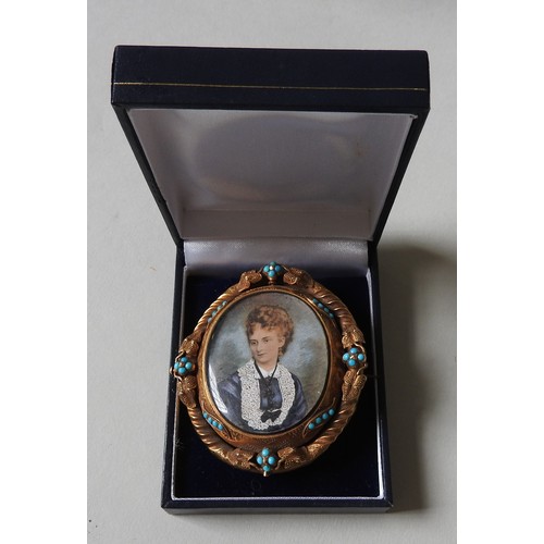 506 - A LATE VICTORIAN PORTRAIT BROOCH, the portrait picture mounted in an ornate oval pinchbeck brooch, w... 