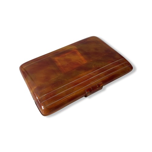 508 - A BAKELITE VANITY CASEIn tortoise shell style, with comb, three hinged opening compartments and mirr... 