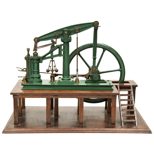 162 - A MODEL OF A 19TH CENTURY BEAM PUMPING ENGINE with large five spoke flywheel mounted on an oak platf... 