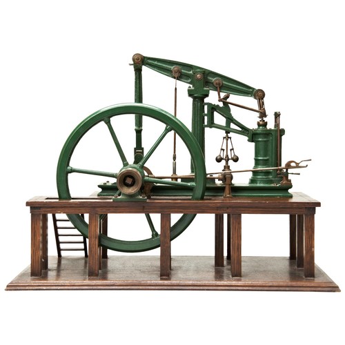 162 - A MODEL OF A 19TH CENTURY BEAM PUMPING ENGINE with large five spoke flywheel mounted on an oak platf... 