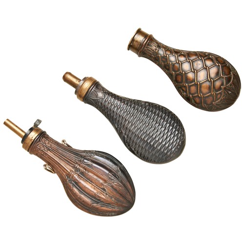 76 - A 20TH CENTURY COPPER AND BRASS POWDER FLASK embossed with a faux basket weave exterior, another  wi... 