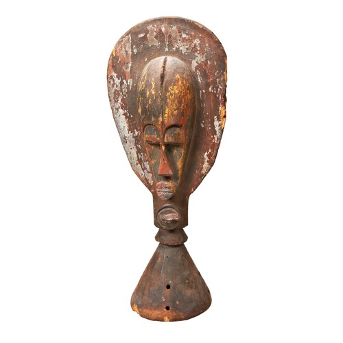 73 - A WEST AFRICAN CARVED WOODEN HELM with a paddle shaped crest, a mask on one side and a crocodile on ... 