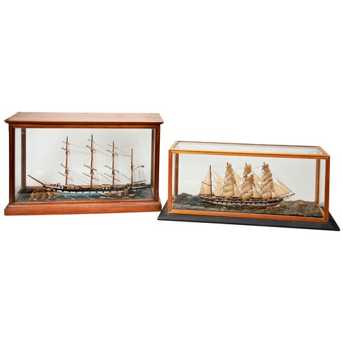 195 - A HANDBUILT MODEL OF A FOUR MASTED SCHOONER on a naturalistic sea with two smaller vessels and displ... 