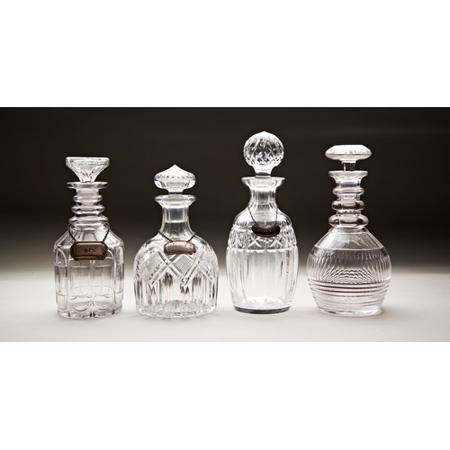 334 - A VICTORIAN CUT GLASS DECANTER OF OCTAGONAL FORM and three other decanters with three silver labels ... 