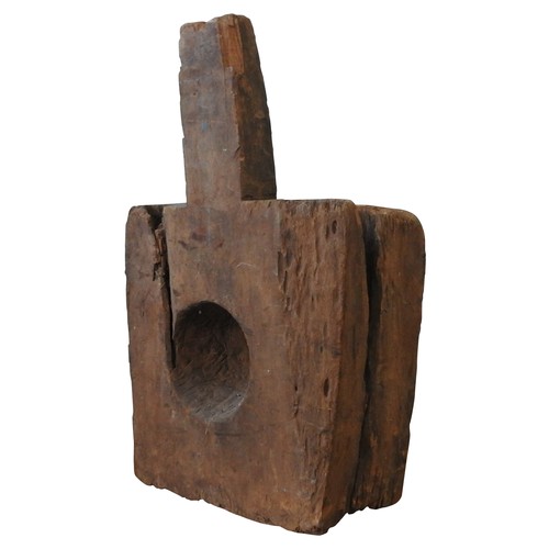 605 - INDONESIAN WOODEN BLOCK MORTAR with circular aperture and side bar52 H X 37 W X 48 D cms