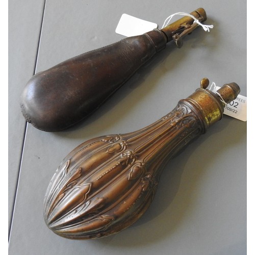 402 - A 19TH CENTURY COPPER AND BRASS POWDER FLASK with fluted foliate decoration and a leather shot flask... 