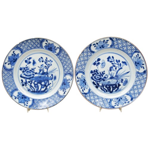 164 - PAIR OF BLUE AND WHITE DISHESKANGXI PERIOD (1662-1722)each centrally decorated with peacock amongst ... 