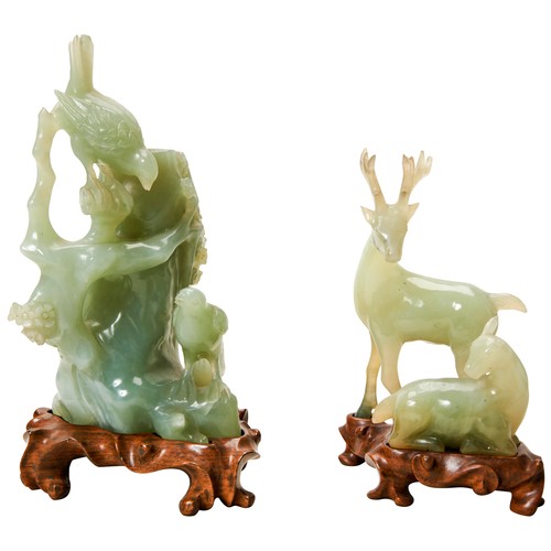 343 - TWO GREEN HARDSTONE GROUPS20TH CENTURYone depicting two deer, the other birds perched on a tree stum... 