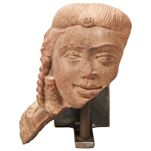 503 - A FINELY CARVED SANDSTONE HEAD FRAGMENT OF A DEITY, PROBABLY NORTHERN INDIAN, with finely detailed h... 