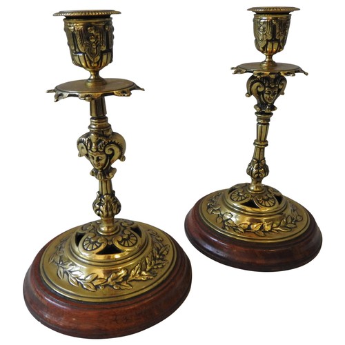 107 - A PAIR OF VICTORIAN LACQUERED BRASS CANDLESTICKS, in the Renaissance style, late 19th century, on ci... 