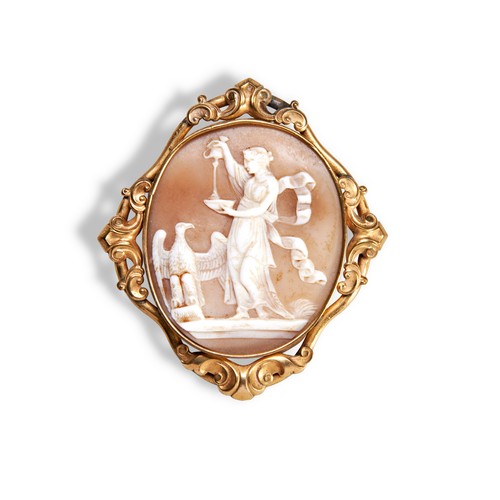 381 - A 19TH CENTURY SHELL CAMEO BROOCHDepicting a robed female figure pouring from a cup next to an eagle... 