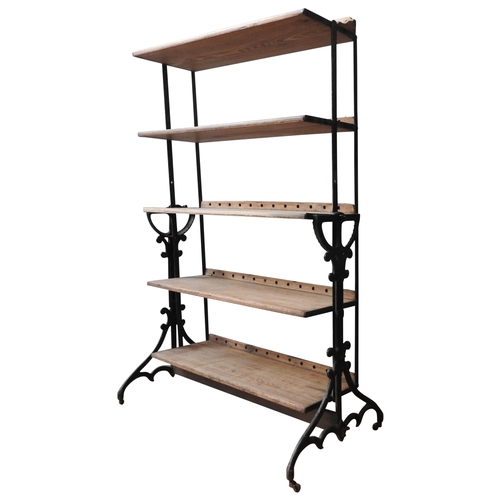 13 - AN INDUSTRIAL STYLE FIVE TIER BOOKSHELF, comprised of a heavy duty cast-iron stand, and five graduat... 