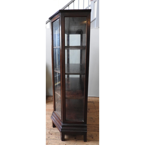 30 - A CONTEMPORARY HARDWOOD DISPLAY CABINET, with canted sides, the two glazed doors open to reveal thre... 