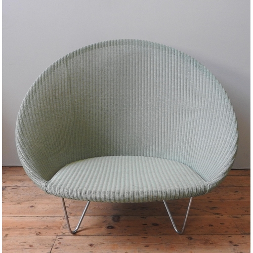 33 - A VINCENT SHEPHERD 'GIPSY LOUNGE' CHAIR, 'Old Lace' colour, polyethylene wicker on steel base. 93 x ... 
