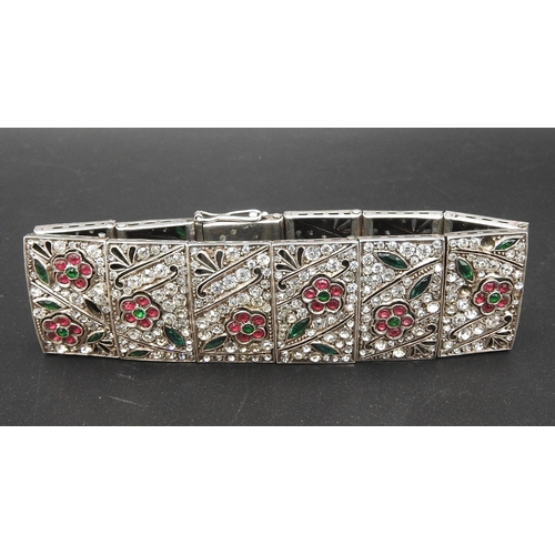 369 - A SILVER AND PASTE BRACELET, circa 192012 panels each set with white pink and green paste in a flora... 