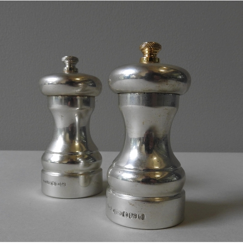 344 - A SILVER ENCASED 'PETER PIPER' PEPPER MILL AND MATCHING SALT MILL, by Park Green, circa 1982, both m... 