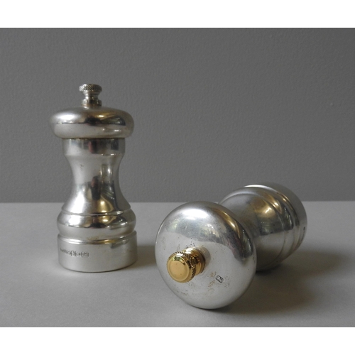 344 - A SILVER ENCASED 'PETER PIPER' PEPPER MILL AND MATCHING SALT MILL, by Park Green, circa 1982, both m... 