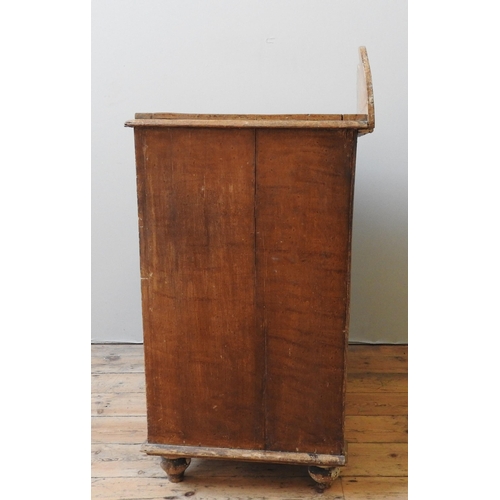 47 - A 19TH CENTURY PINE CUPBOARD, with shaped back panel, moulded top, over two panelled doors, on turne... 