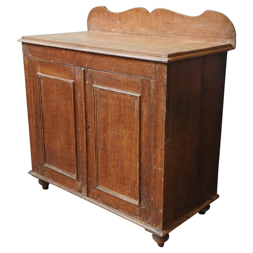 47 - A 19TH CENTURY PINE CUPBOARD, with shaped back panel, moulded top, over two panelled doors, on turne... 