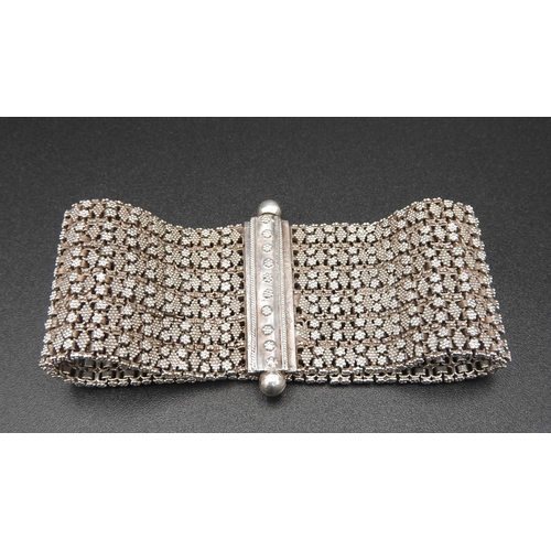 379 - A HEAVY SILVER BRACELETwith fine granulation decoration on a flexible woven chain bracelet.UnmarkedW... 