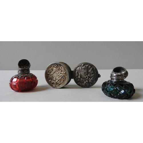 341 - TWO VICTORIAN SILVER MOUNTED SCENT BOTTLES AND A WHITE METAL PILL BOX, the ruby and emerald glass sc... 