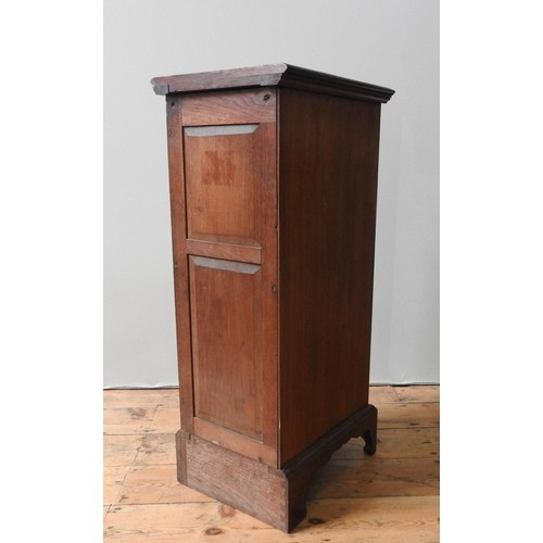 65 - AN EDWARDIAN MAHOGANY CABINET, of narrow form, with a carved frieze pane with foliate and Grecian ur... 