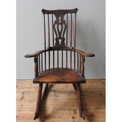 67 - AN 18TH CENTURY WINDSOR ROCKING CHAIR, with yoke shape top rail, pierced central splat and turned ba... 