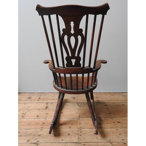 67 - AN 18TH CENTURY WINDSOR ROCKING CHAIR, with yoke shape top rail, pierced central splat and turned ba... 