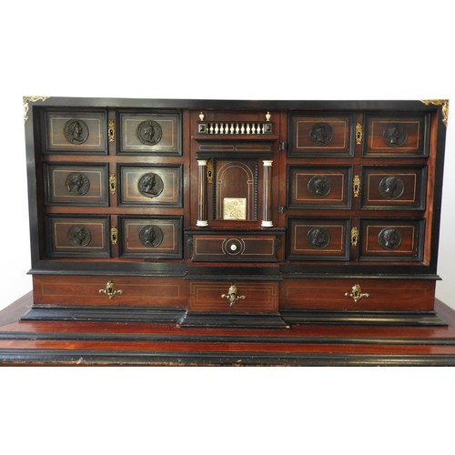 69 - A CONTINENTAL 19TH CENTURY ROSEWOOD VARGUENO CABINET, with brass inlay and gilt metal mounts, the to... 