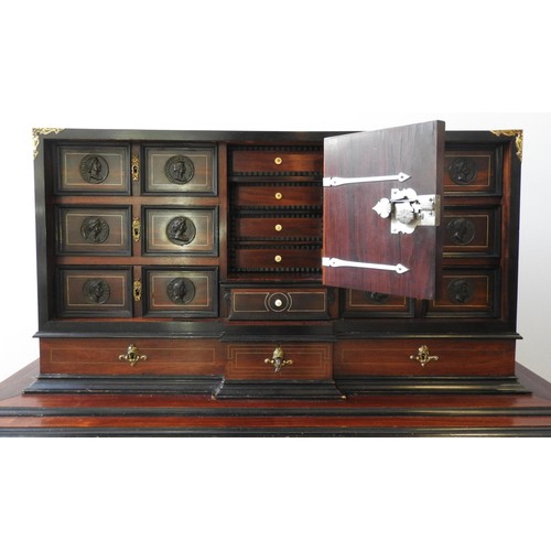 69 - A CONTINENTAL 19TH CENTURY ROSEWOOD VARGUENO CABINET, with brass inlay and gilt metal mounts, the to... 