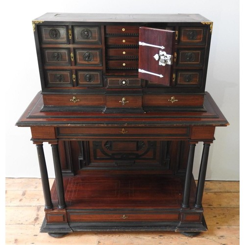 69 - A CONTINENTAL 19TH CENTURY ROSEWOOD VARGUENO CABINET, with brass inlay and gilt metal mounts, the to... 