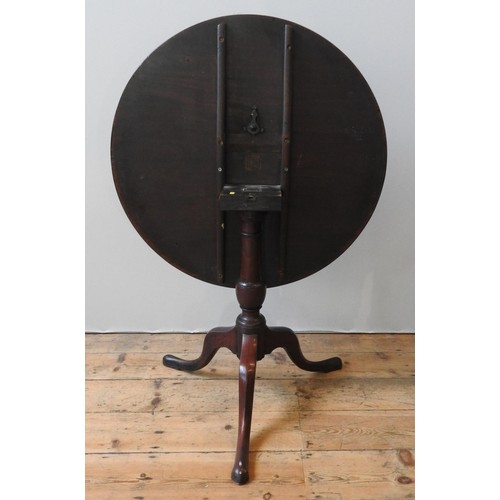 72 - A GEORGE III MAHOGANY TILT-TOP TRIPOD TABLE, the single piece top raised on a turned baluster pedest... 